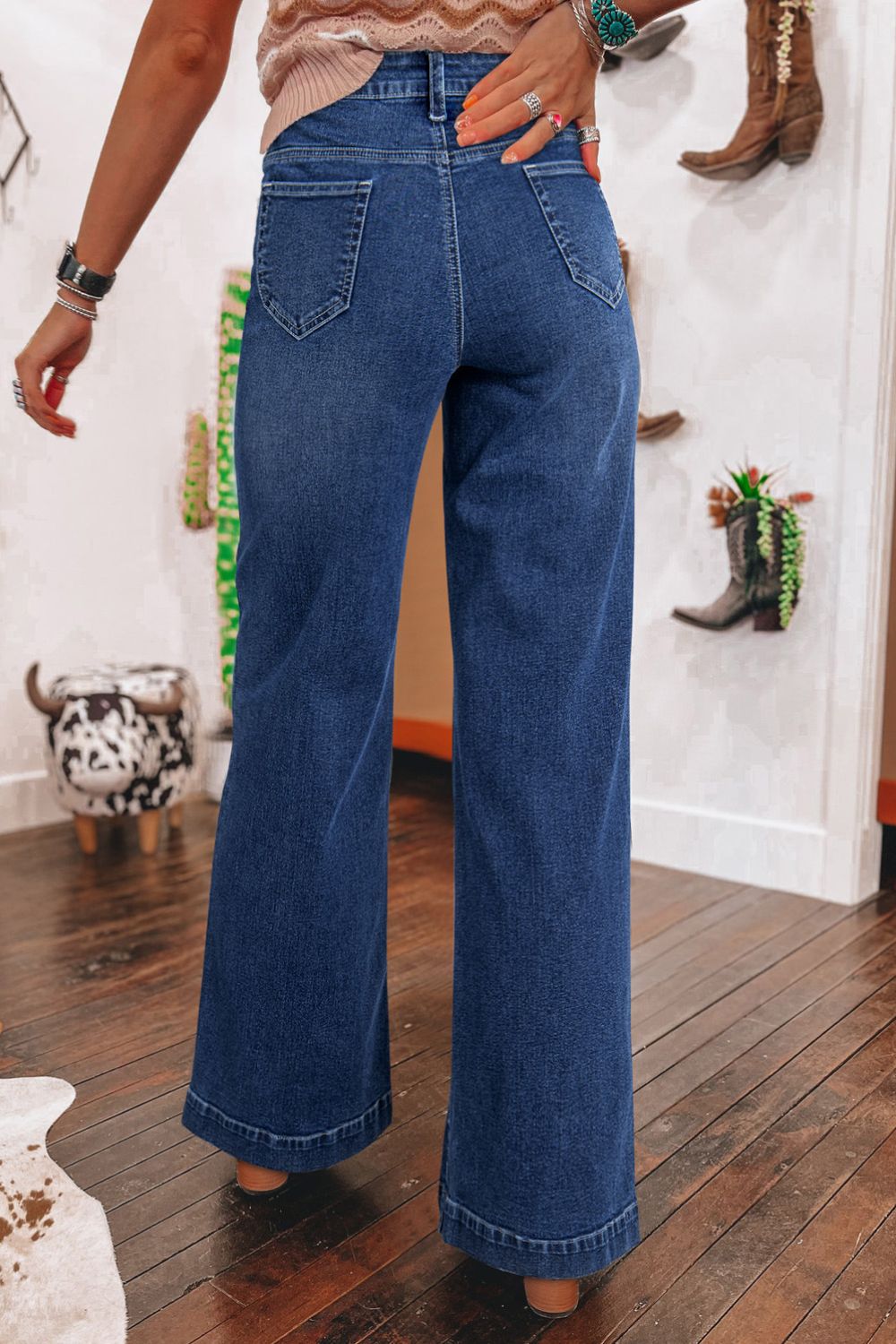 Medium wash denim wide leg jeans with buttoned fly and utility pockets.