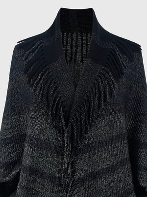 Textured black knit capelet with fringe detail and open front.