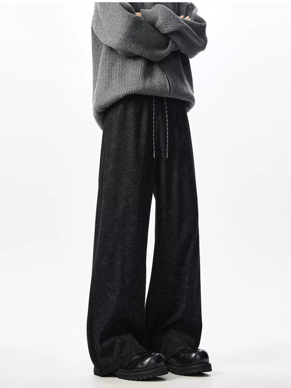 Textured black wide leg drawstring sweatpants with adjustable tie.