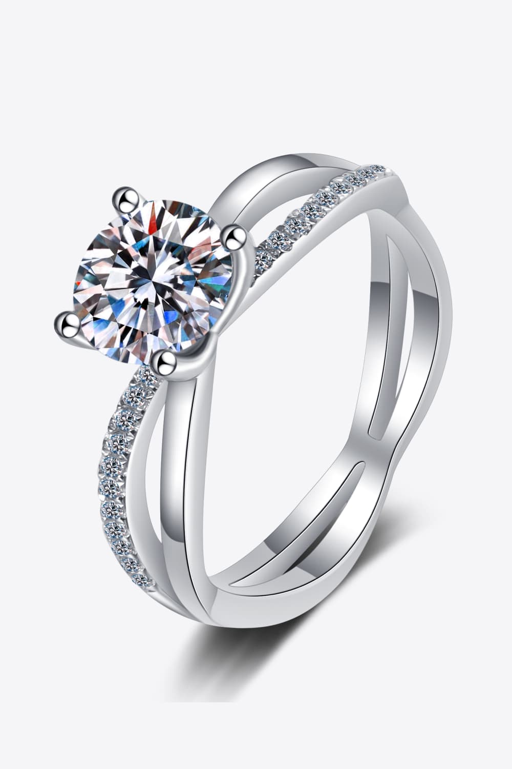 Silver crossover ring with moissanite solitaire and pavé band detail