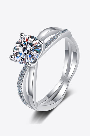 Silver crossover ring with moissanite solitaire and pavé band detail