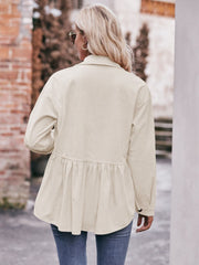 Beige corduroy peplum shirt jacket with buttoned cuffs and gathered waist detail.