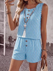 Blue gingham two-piece set with button-down top and shorts.
