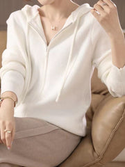 White ribbed knit zip-through hoodie with drawstring and silver zipper detail.