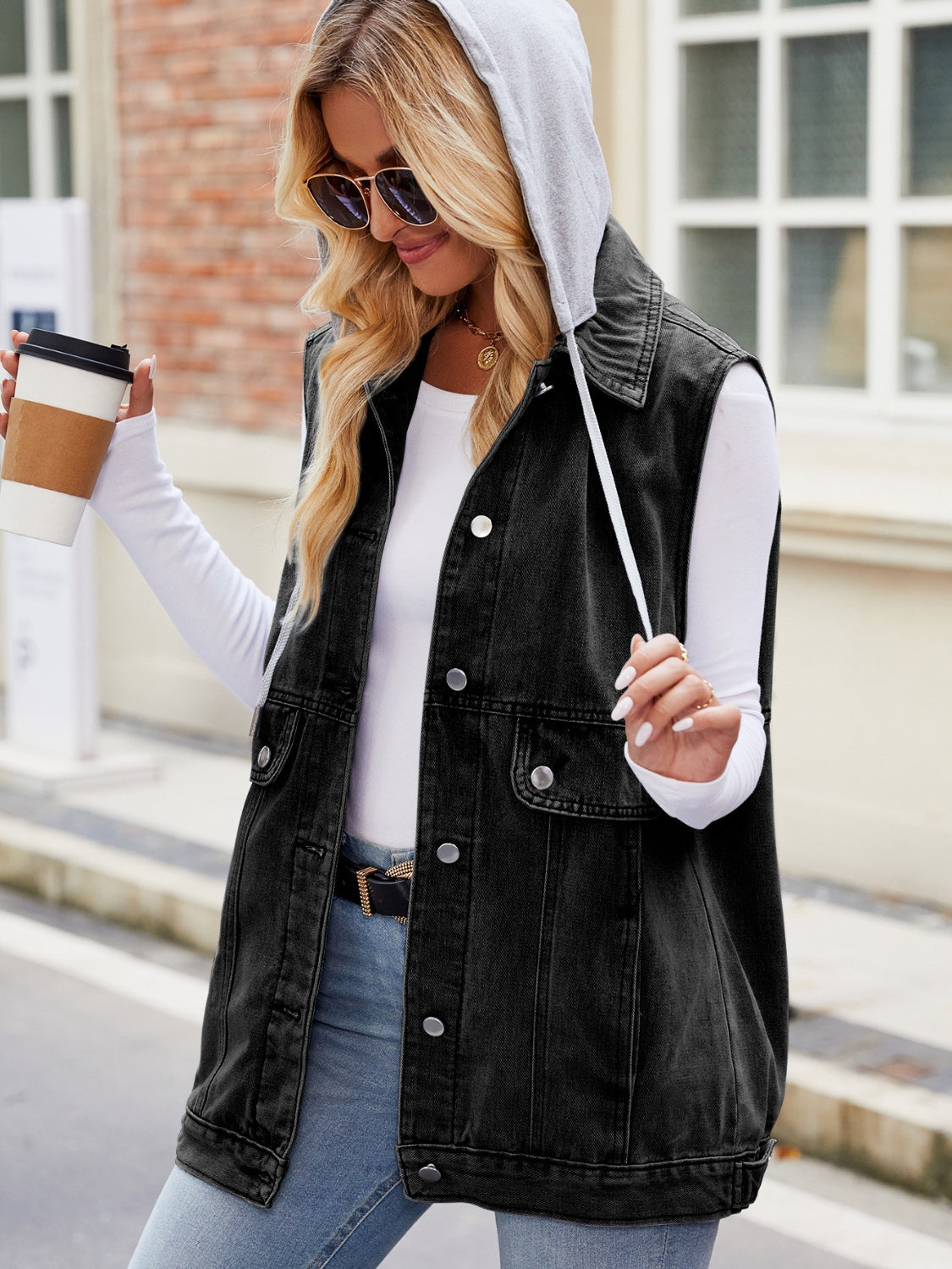 Black denim utility gilet with grey hood and button closures.