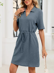 Blue gray textured polo dress with short sleeves and adjustable drawstring waist.