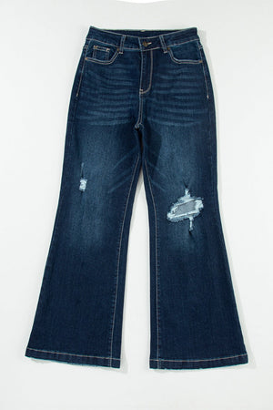 Dark wash denim widecut jeans with distressed details and rough hem