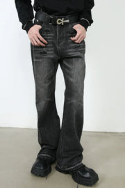 Distressed flare jeans in washed black denim with ripped details and a bootcut leg.
