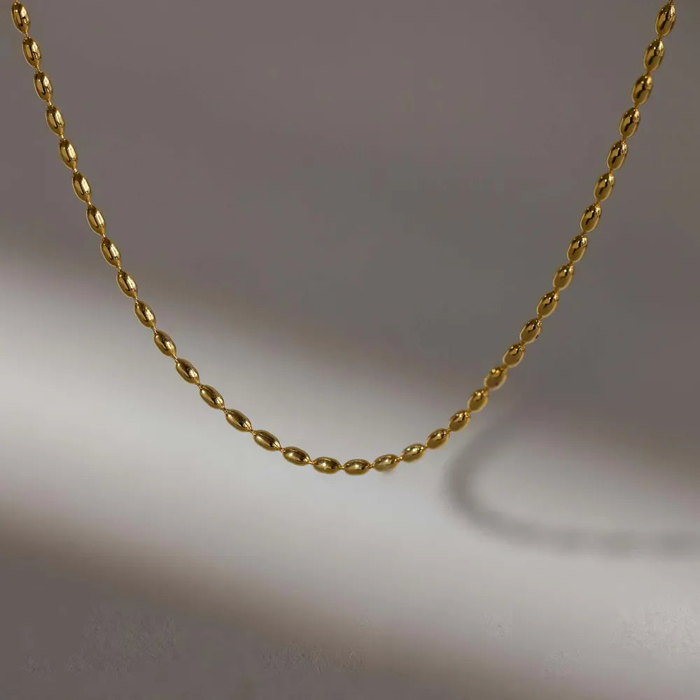 Gold capsule chain necklace with oval beads