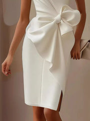White sleeveless dress with a large bow detail and side slit.