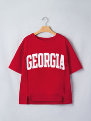 Red cotton blend tee with white GEORGIA lettering, drop shoulders, and side slits.