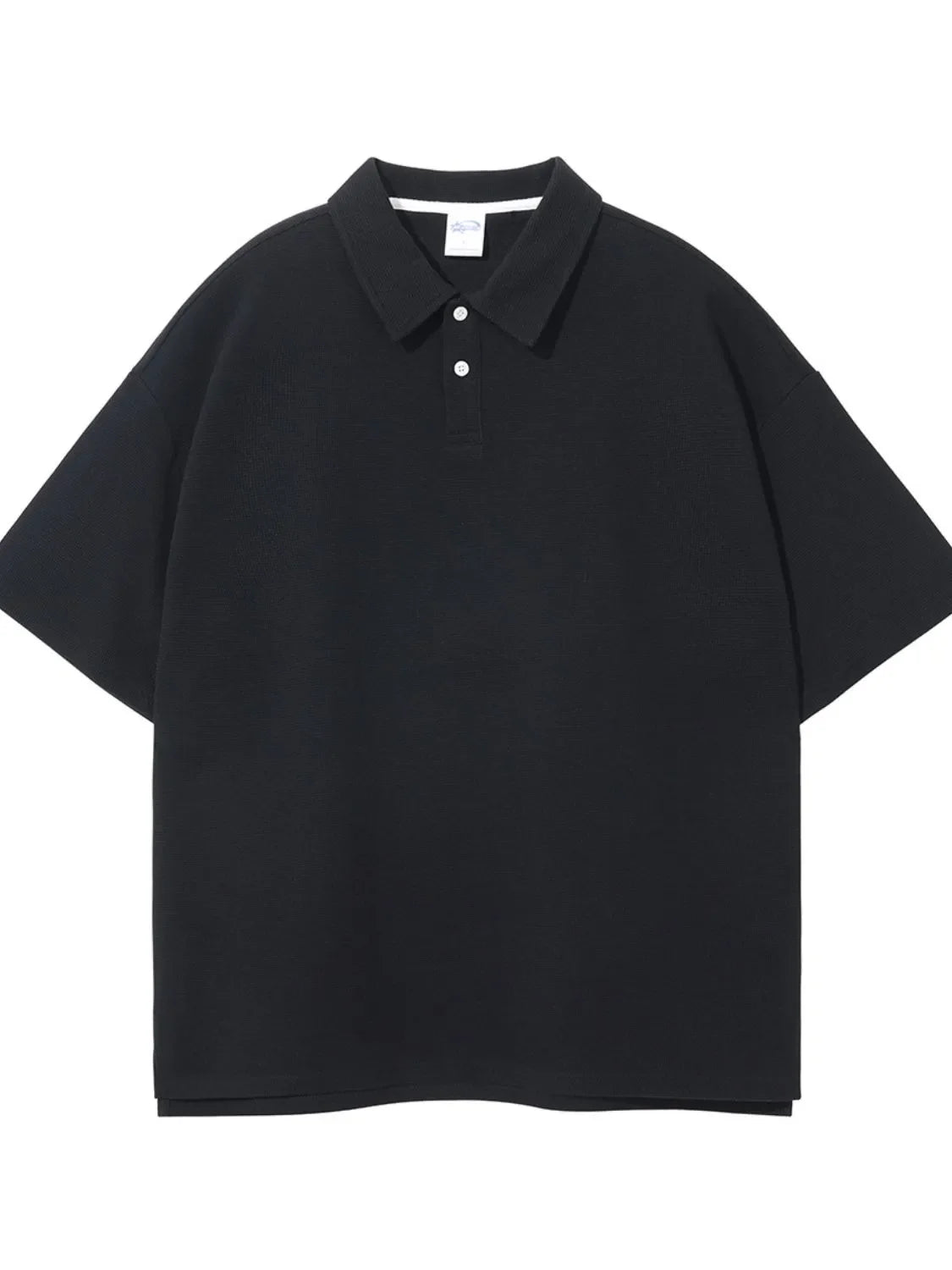 Black textured boxy polo shirt with short sleeves and a two-button placket.