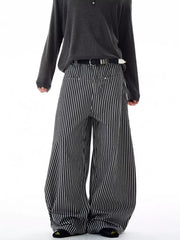 Men's black and white striped wide-leg sweatpants with a belt.