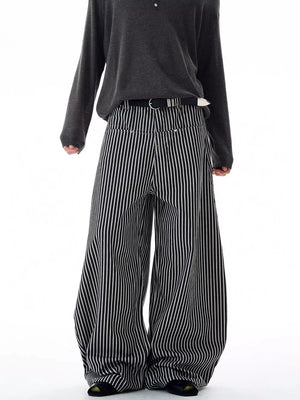 Men's black and white striped wide-leg sweatpants with a belt.
