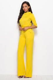 Yellow high-neck belted palazzo jumpsuit with 3/4 sleeves and wide legs.