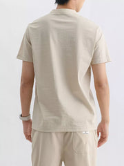 Men's short sleeve t-shirt in apricot with a mandarin collar.
