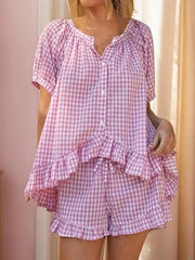 Pink gingham ruffle-trimmed two-piece pajama set with button-front top and drawstring shorts.