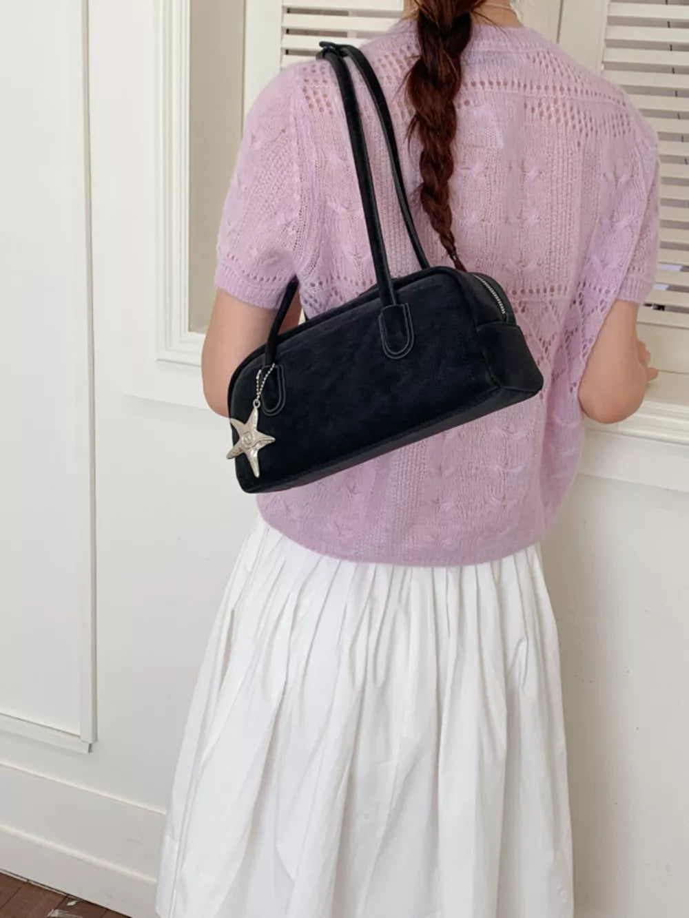 Black shoulder bag with star charm detail