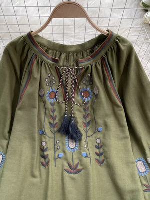 Green embroidered tie neck blouse with billowy sleeves and floral detail