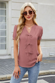 Dusty pink textured blouse with tie-front detail and V-neck