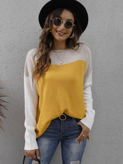 Colorblock crewneck knit sweater in gold, cream, and white with side slits.