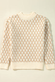 Cream diamond knit sweater with crew neck and ribbed cuffs and hem.