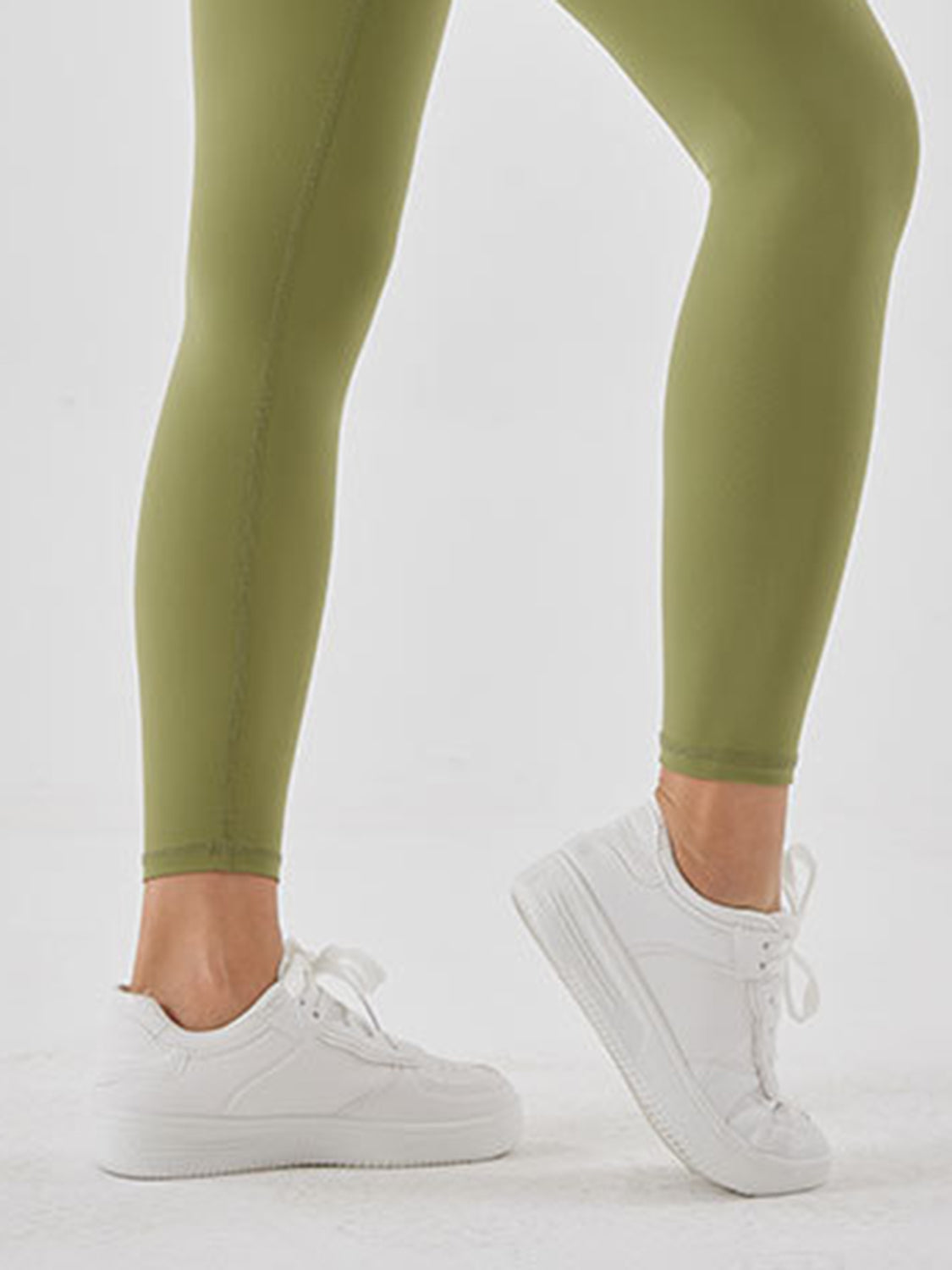Matcha green high-waist leggings with white sneakers
