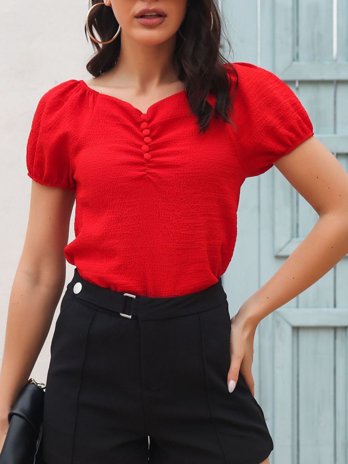 Red ruched button-front puff sleeve blouse with textured fabric