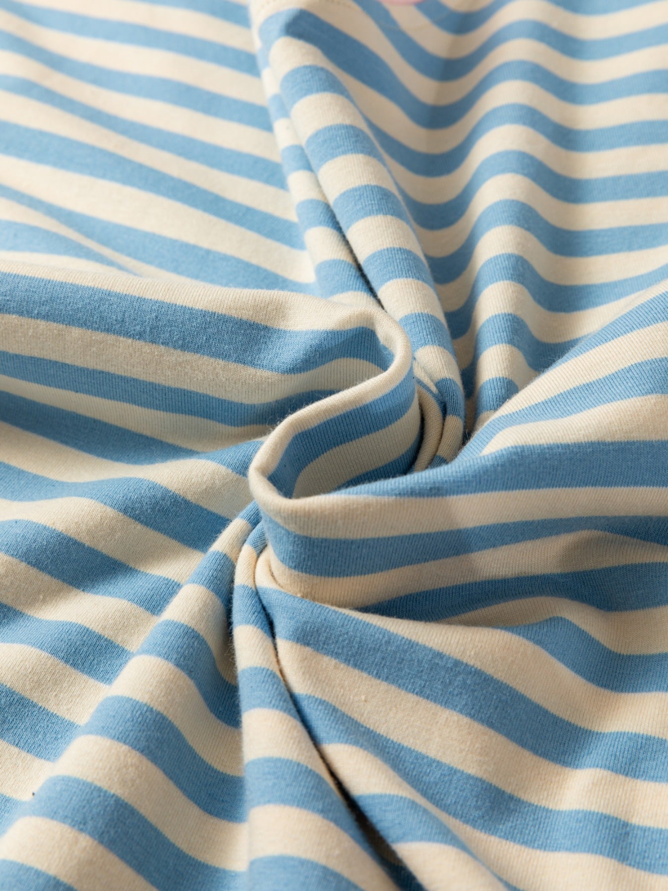 Light blue and cream striped cotton t-shirt with a soft, casual feel.