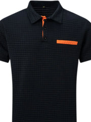 Navy textured polo shirt with orange contrast pocket and placket detail.