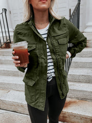 Army green utility jacket with multiple pockets and a zip-up front, styled casually.