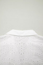 White cotton mini dress with eyelet embroidery and collar detail.