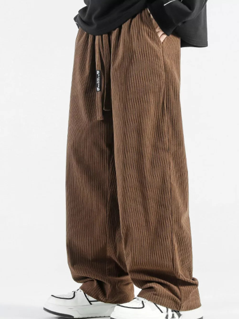 Brown corduroy wide-leg sweatpants with drawstring and pockets.