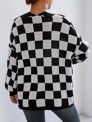 Checkerboard knit cardigan in black and white with balloon sleeves.