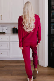 Plush lounge set in Deep Rose, relaxed fit joggers with cuffed ankles and matching long-sleeve top.