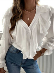 White V-neck blouse with cascading ruffles and button front, styled with jeans.