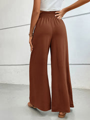 Textured palazzo lounge trousers in dark brown with a smocked waistband.