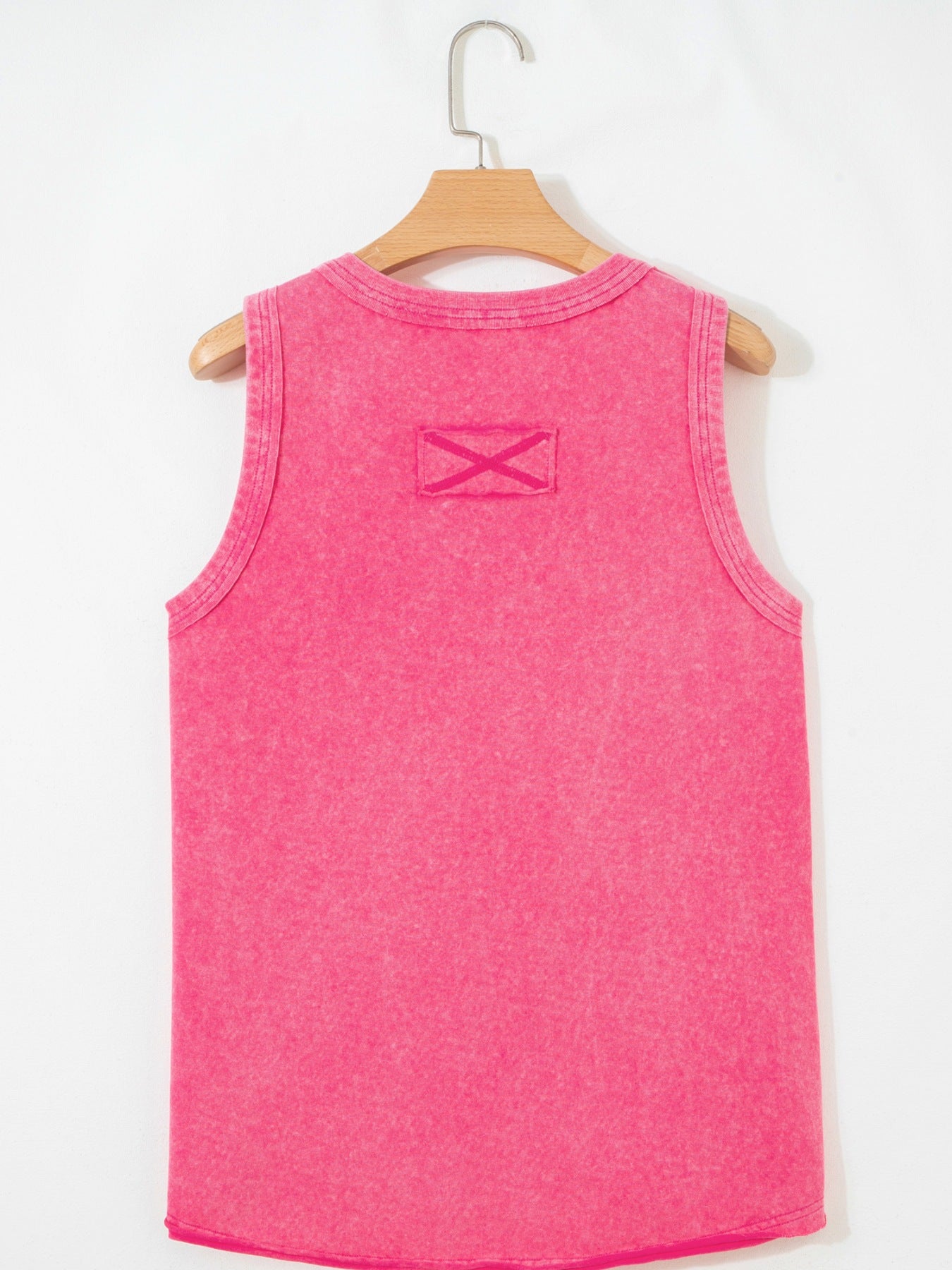 Textured cotton tank top in bright pink with a small X detail on the back yoke.