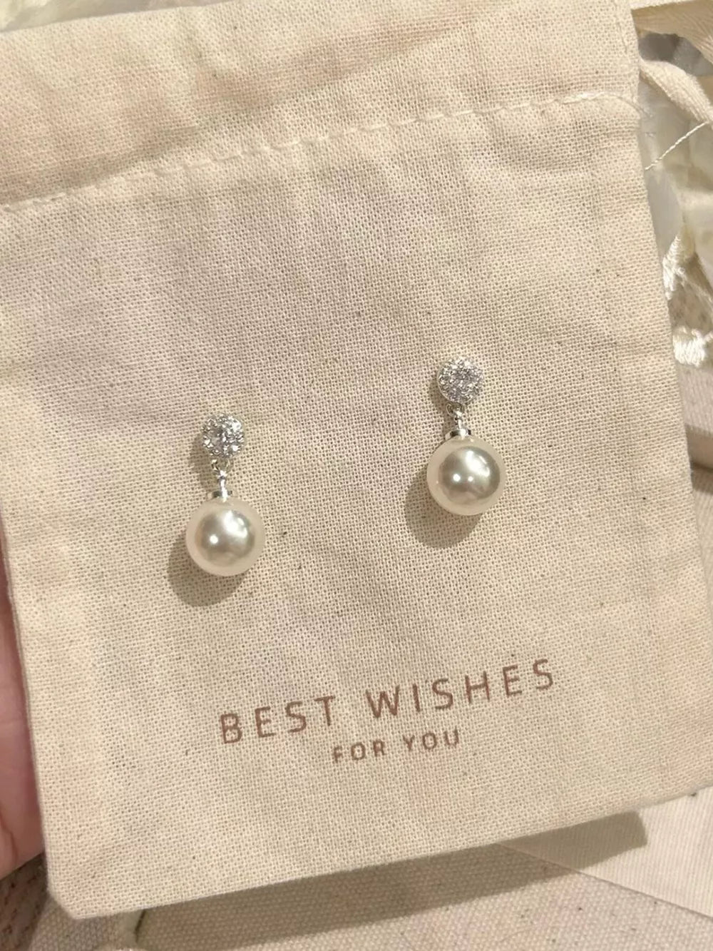 Lustrous pearl drop earrings with zircon accents on 925 silver posts.