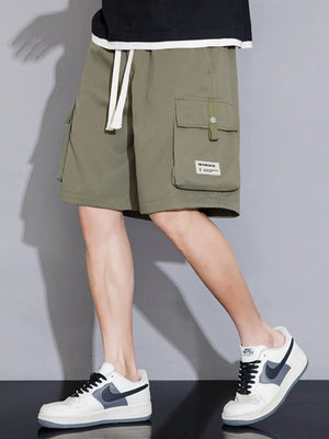 Sage green cargo shorts with white drawstring and multiple pockets.