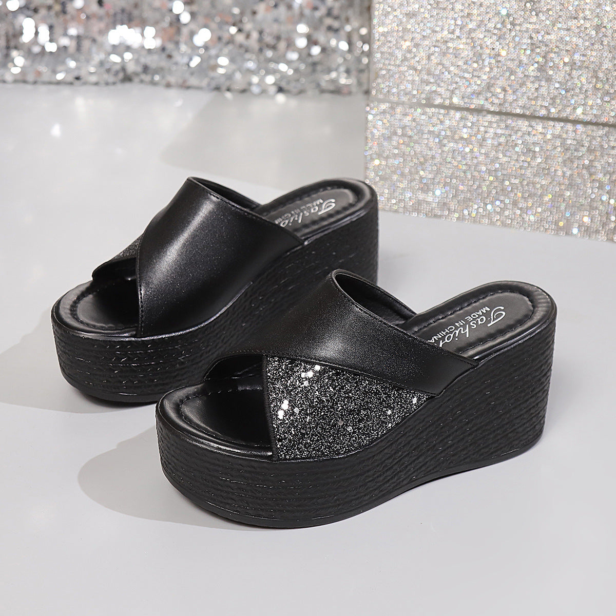 Black glitter-embellished open-toe wedge sandals with cross-over straps.