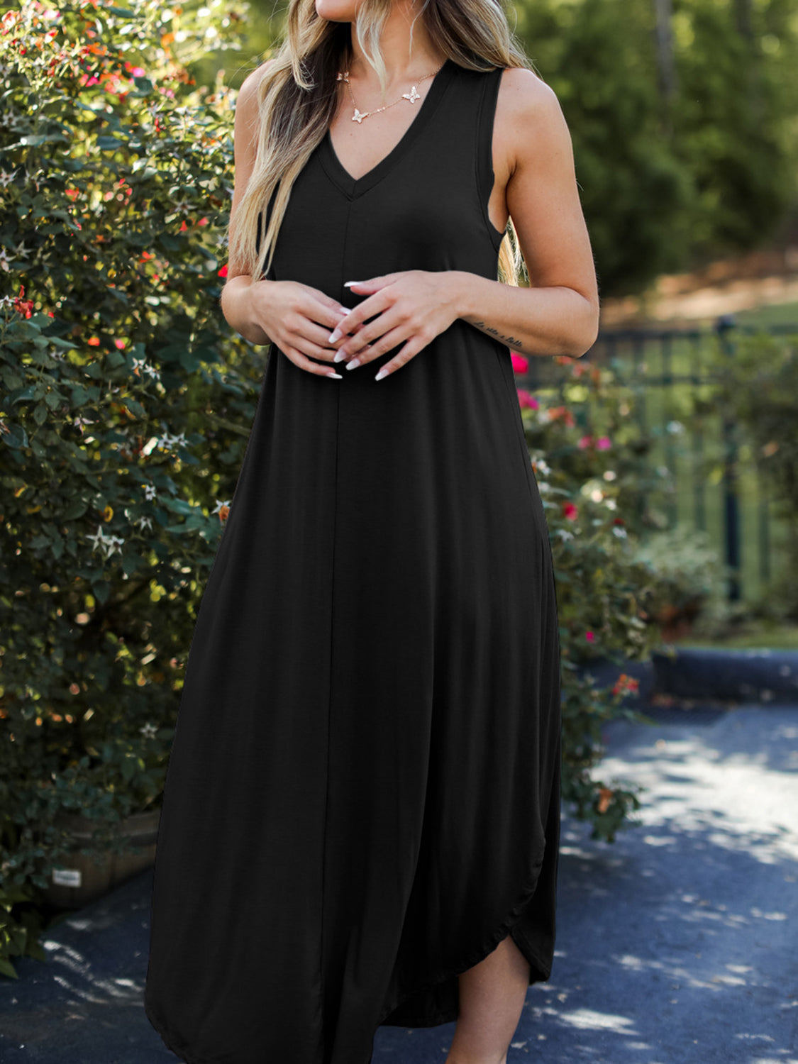 Black sleeveless V-neck midi dress with asymmetrical hemline