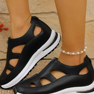 Black cutout wedge sneakers with zipper detail and chunky sole.