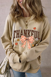 Khaki graphic sweatshirt with "THANKFUL" text and a leopard print bow.