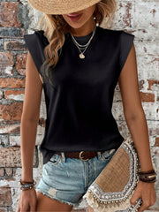 Black cap sleeve blouse with padded shoulders, styled with denim shorts and a straw hat.