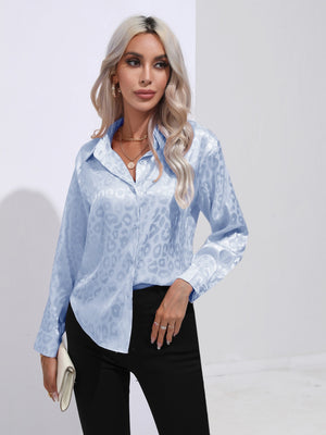 Light blue satin leopard print button-down shirt with a collared neckline and long sleeves.