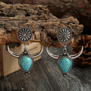 Southwestern crescent drop earrings with turquoise stones and bull horn design in silver alloy.