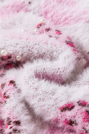 Fuzzy blush pink knit sweater with jacquard heart pattern and pearl embellishments.