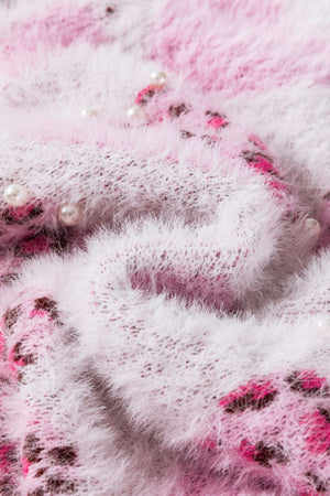 Fuzzy blush pink knit sweater with jacquard heart pattern and pearl embellishments.