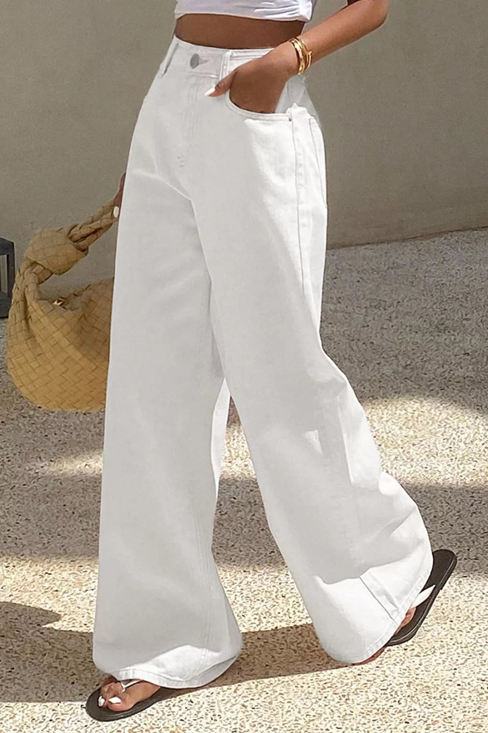 White denim casual wide-leg high-waisted jeans with button fly and pockets.